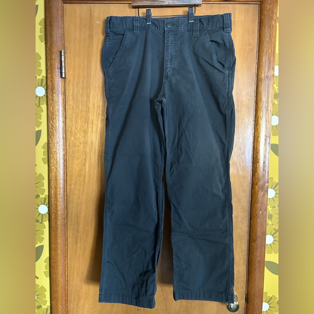 Men's dark grey Carhartt work pants.